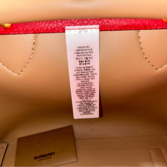 Authentic Burberry medium-sized tote in red, featuring gold studs on the front. - Picture 10 of 11